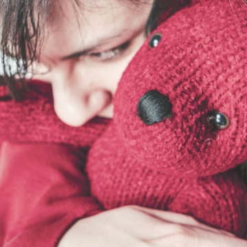 girl hugging a bear