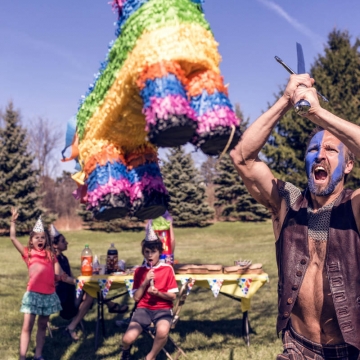 A person hitting a pinata with determination and force