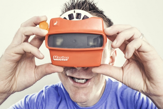 A man looking through a viewfinder
