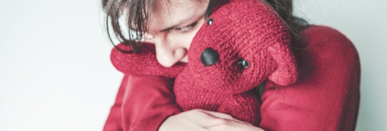 girl hugging a bear
