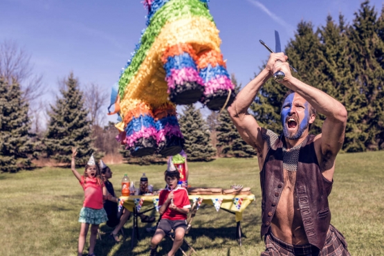 A person hitting a pinata with determination and force
